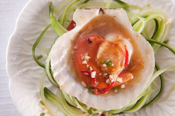 Scallops in sweet chilli sauce on bed of cucmber.