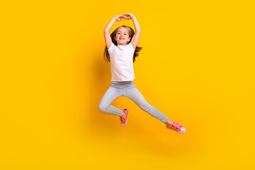 Full length photo of funky sweet schoolgirl dressed white t-shirt dancing jumping high isolated...