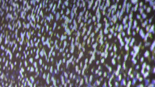 Close up view at a plasma tv while showing television white noise.
