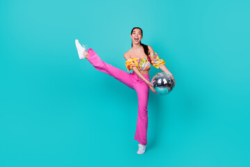 Full body photo of impressed young lady hold disco ball dance wear top pants shoes isolated on...