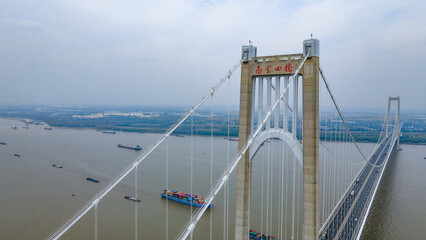 Aerial photography of Nanjing Fourth Bridge and busy transport ships in the Yangtze River in Nanjing City, Jiangsu Province, China in the smog
