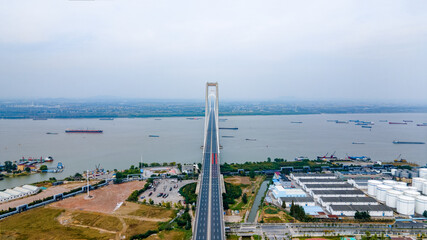 Aerial photography of Nanjing Fourth Bridge and busy transport ships in the Yangtze River in Nanjing City, Jiangsu Province, China in the smog