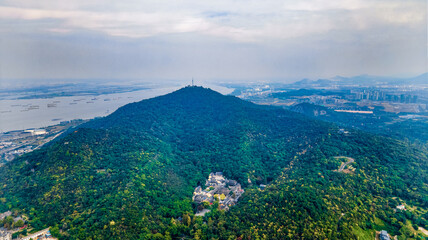 Aerial photography of smog and industrial pollution shrouded in Qixia Mountain, the Yangtze River and busy transport ships in Nanjing City, Jiangsu Province, China