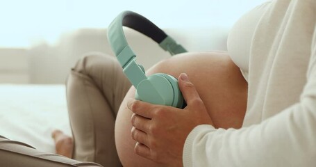Close up, unknown pregnant woman put headphones on belly, play classical tune for prenatal child development, enjoy carefree rest at home. Pregnancy music for expectant mother and unborn baby concept - Powered by Adobe