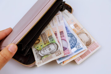 Croatian kunas in a wallet of different denominations on a white background.