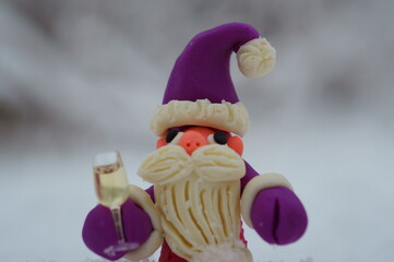 Santa Claus holding a glass of champagne in his hand. 