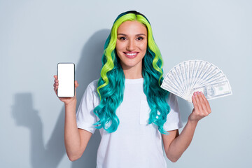 Photo of adorable sweet vibrant gradient hair girl dressed t-shirt rising money fan device empty space isolated white color background