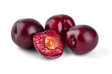 Juicy Red plums with a half, isolated on white background.