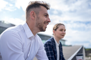 Businesspeople talking during coffee break on embankment