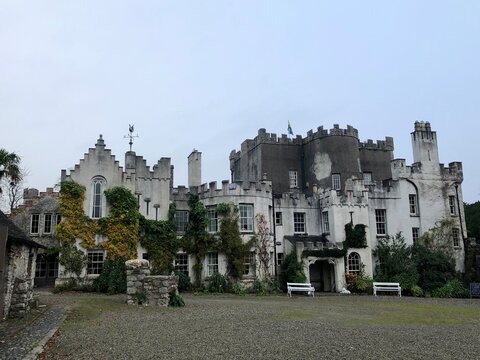Huntington Castle & Gardens, old irish castles, Clonegal, County Carlow, Ireland. Panorama of a beautiful ancient white castle overgrown with green bushes. Best medieval Irish architecture. 