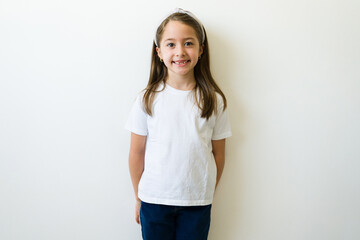 Cute little girl with a white basic mockup t-shirt