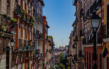Exterior view of beautiful historical buildings in Madrid, Spain, Europe. Colorful Mediterranean urban street in the former Jewish quarter, Lavapiés, Embajadores neighborhood of the Spanish capital. - obrazy, fototapety, plakaty