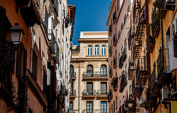 Exterior view of beautiful historical buildings in Madrid, Spain, Europe. Colorful Mediterranean urban street in the former Jewish quarter, Lavapi&eacute;s, Embajadores neighborhood of the Spanish capital.