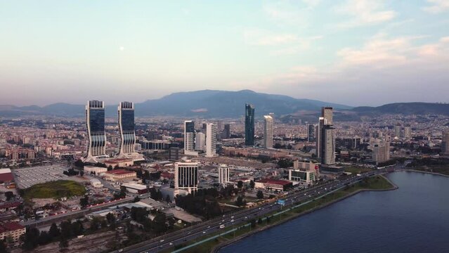 Izmir, Turkey - April 15, 2022: Aerial footage view of Izmir city from above Izmir bay sea with the skyscrappers which ones Folkart Towers, mistral, Ege Perla and Bayrakli region