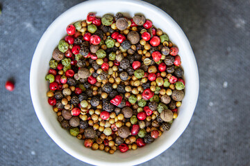 peppercorn 5 spices red, black, green and white pepper, coriander fresh food spice on the table copy space food background 