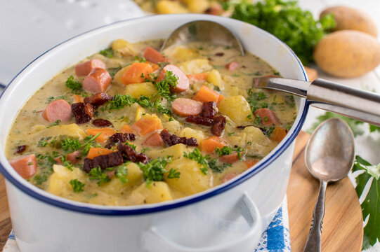 Potato soup with bacon, sausage and vegetables. Traditional german 