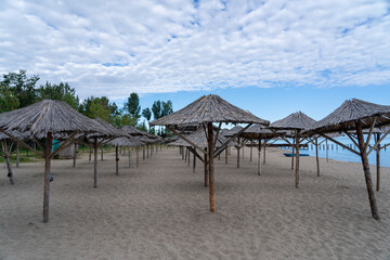 Clean beach with straw umbrellas