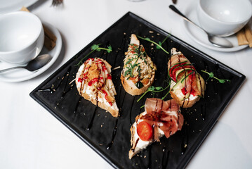 Bruschetta with jamon. Sandwich with jamon. Restaurant serving dishes. Autumn table setting.