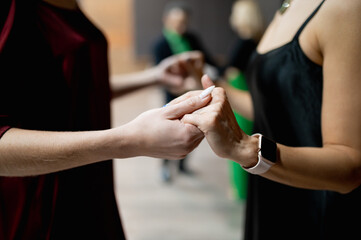 the hands of two girls hold each other in a dance