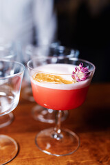 Pink gin cocktail with red blood orange and ice. An alcoholic, refreshing drink. copy space.