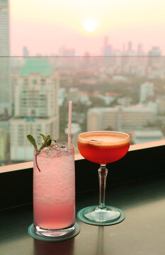 Pair Of Cocktails On The Rooftop Bar Counter At Sunset