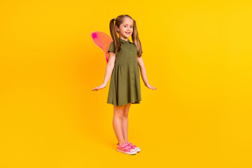Full length photo of cheerful satisfied girl wear butterfly wings costume isolated on yellow color background