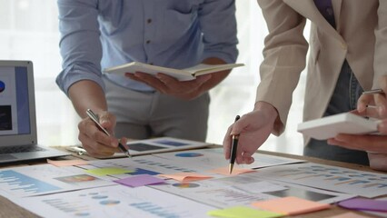Group of business people meeting to plan marketing activities view graph, chart, financial account, balance sheets of various companies to develop and expand the business further.