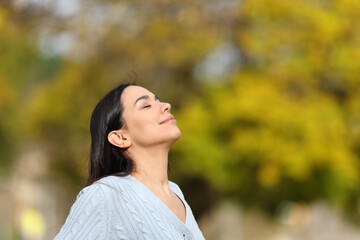 Woman relaxing breathing in a park fresh air