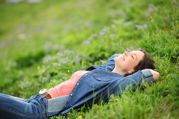 Woman lying on the grass in a park relaxing