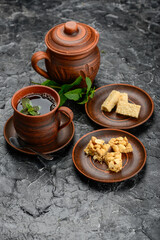 oriental breakfast in clay dishes on the table with tea vertical photo
