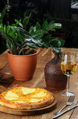 Georgian flatbread with meat and cheese on the table with wine
