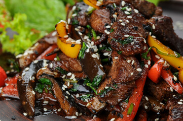 roasted veal meat with pepper and cherry tomatoes in a plate macro
