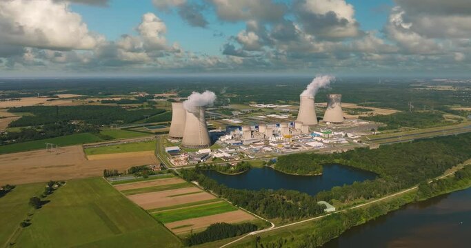 Aerial panoramic flight of around the nuclear power plant. Carbon dioxide emissions, energy of smoke and steam. Ecology and pollution of nature.