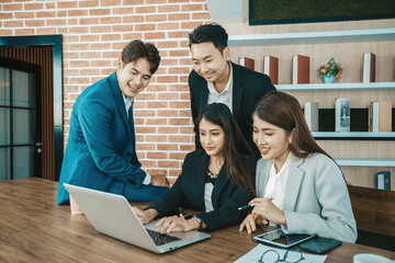 Young asian business people looking at screen during video conference in office