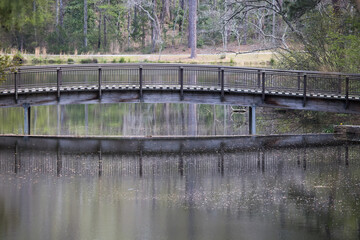 Fototapeta na wymiar Bridge over a quiet lake
