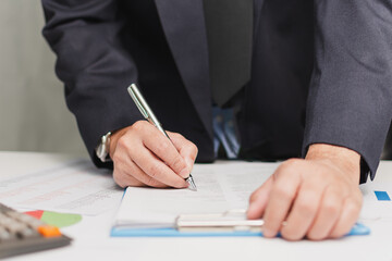 professional businessman wear suit hand holding pen writing and sign paperwork or document finance...
