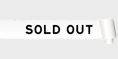 Ripped gray paper background that have word sold out under torn part