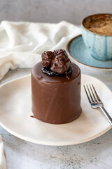 Chocolate cake on gray background. Fruit and cream cake covered with chocolate on the outside. close up