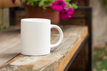 White mug in the garden. - 525344439