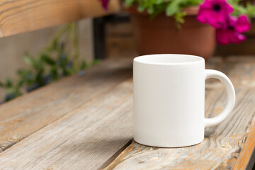 White mug in the garden. - 525344440