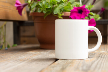 White mug in the garden. - 525344442