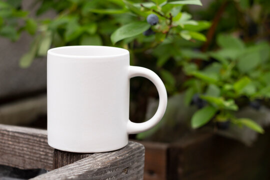 White mug in the garden.