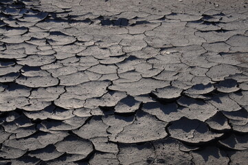 View of cracked black dry ground, natural background