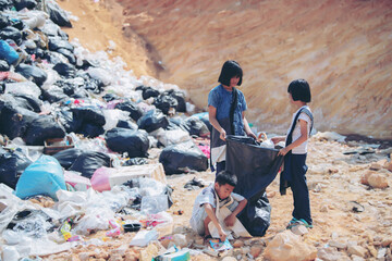 Poor children collecting garbage for sale Concept of pollution and Environment recycling old waste...