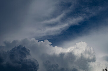 Fototapeta na wymiar Puffy white and grey cloud on clear blue sky