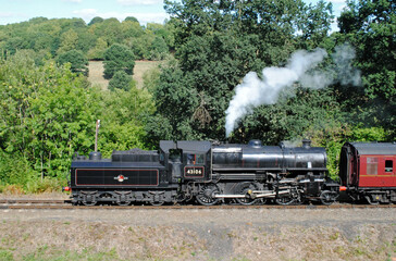 Fototapeta na wymiar Steam Locomotive and Train Approaching on Rural Heritage Railway 