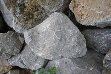Raw grey carbonate limestone sedimentary rock.