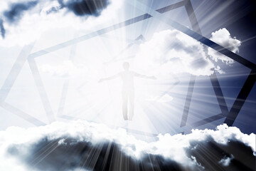 A silhouette of a man flies into a portal in the sky with clouds in the rays of bright light. The concept of freedom of choice, open mind, meditation.