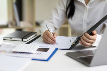 The secretary is writing the memo of the working message in the file.