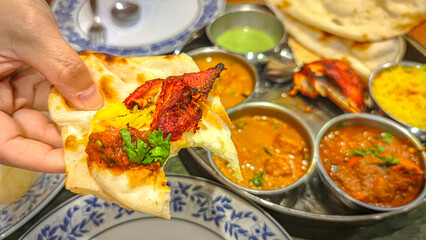 Traditional indian cuisine. Assorted indian food on table in Restaurant. appetizers and Dishes of indian cuisine. Curry, rice, samosa, naan, butter chicken, chutney, spices, Palak Paneer, Tikka, Roti